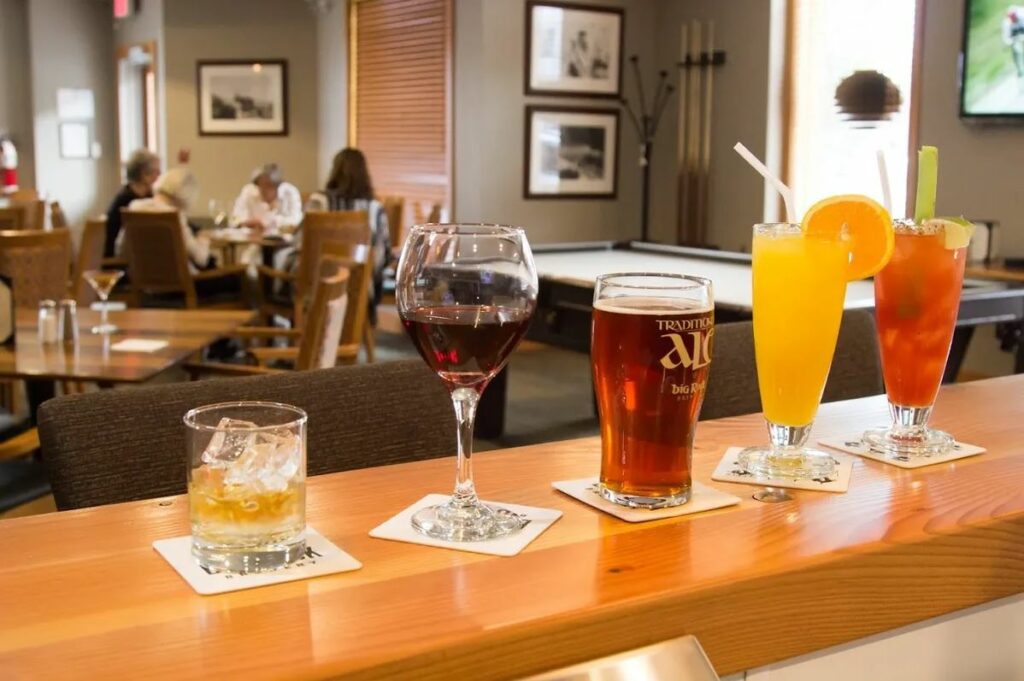 Alcoholic drinks lined up at a bar at The Mineshaft Tavern in Canmore, Alberta 